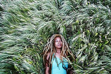 Black woman laying in grass