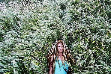 Black woman laying in grass