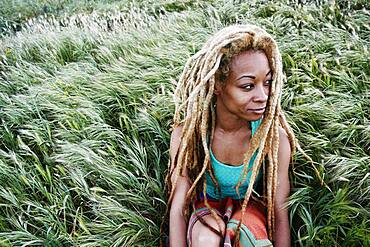 Black woman sitting in grass