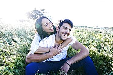 Couple sitting in field