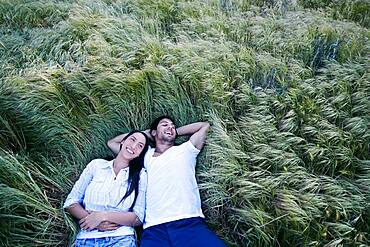 Couple laying in grass