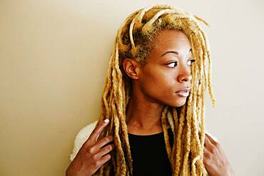 Black woman with dreadlocks looking away