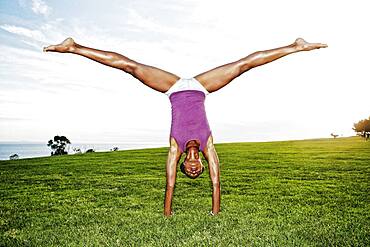 African American woman practicing yoga in park