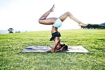 African American woman practicing yoga in park