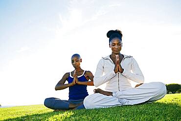 Women meditating in park