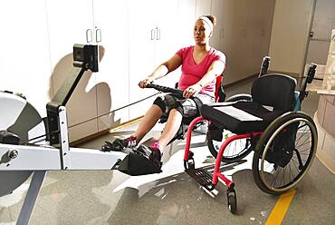 Paraplegic woman working out in physical therapy