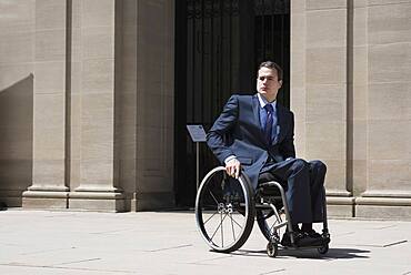 Paraplegic businessman sitting in wheelchair