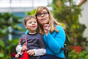 Paraplegic mother and son exploring outdoors