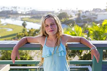 Caucasian girl standing on balcony