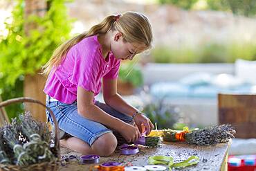 Caucasian girl wrapping dried flower bundle