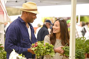 Couple shopping for produce at farmers market