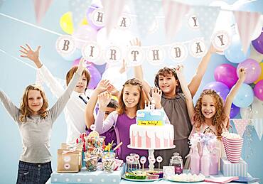 Children cheering at birthday party