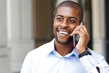 Black businessman talking on cell phone