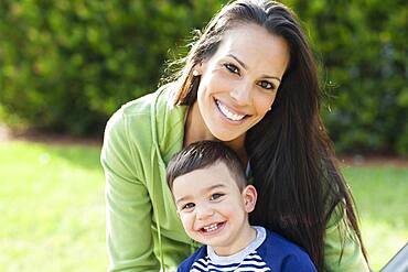 Hispanic mother and son smiling outdoors