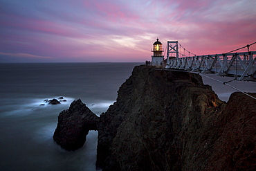 Lighthouse on rocky cliffs over ocean coastline, Sausalito, California, United States