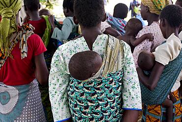 Mothers carrying children and waiting at rural health clinic