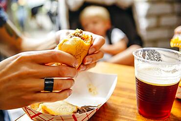 Close up of woman eating burger in restaurant