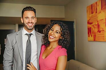 Smiling couple hugging in hotel room