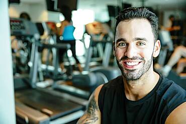 Man using exercise machine in gymnasium