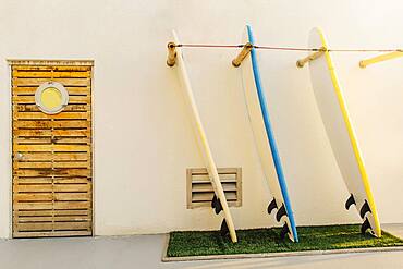 Surfboards in rack on building exterior