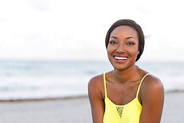 Black woman smiling on beach