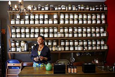 Black woman drinking tea in tea shop