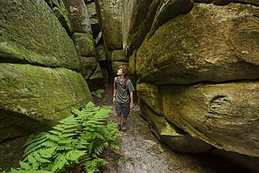 Caucasian teenage boy exploring cave