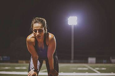 Caucasian athlete resting on sports field