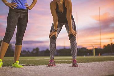 Athletes resting on sports field