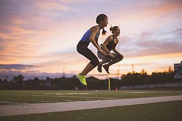 Athletes jumping on sports field