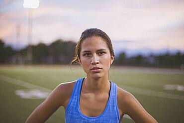 Mixed race athlete standing on sports field