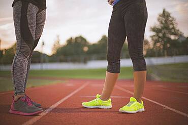 Athletes standing on track on sports field