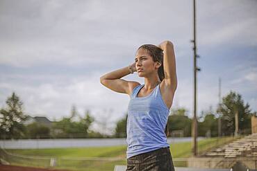 Mixed race athlete standing on sports field