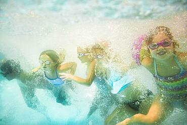 Children underwater in swimming pool