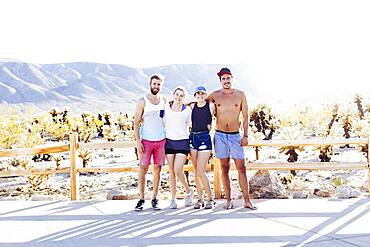 Caucasian friends smiling on desert path