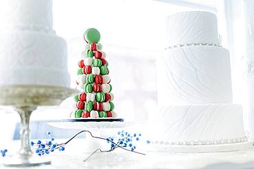 Macaroon and wedding cakes in bakery window