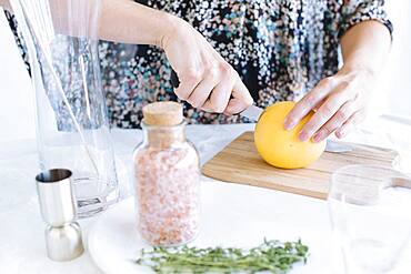 Caucasian woman slicing fruit on counter