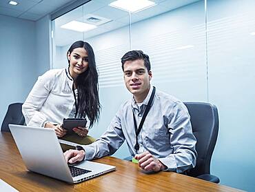 Business people using technology in conference room