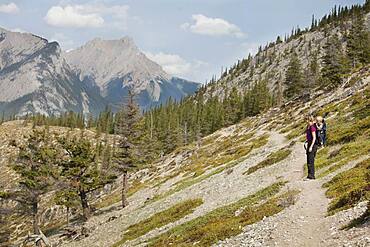 Caucasian mother and son hiking on remote hillside