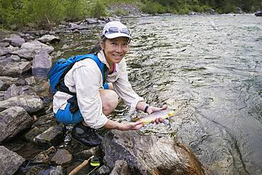 Japanese woman fishing in river