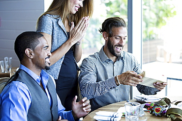 Businessman opening gifts at birthday lunch