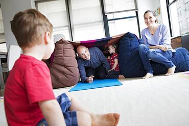 Family playing in blanket fort