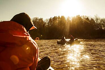 Caucasian fisherman sitting in canoe on river