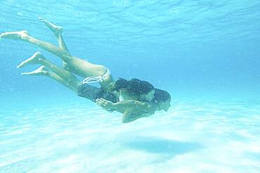 Underwater view of couple swimming in ocean