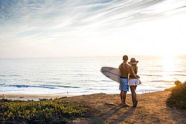 Caucasian couple admiring seascape at beach