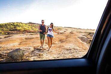 Caucasian couple walking toward car