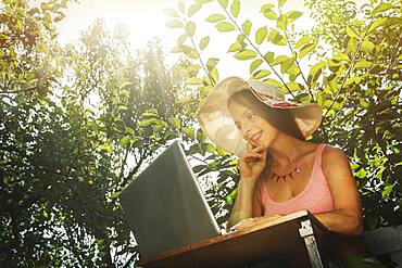 Caucasian woman using laptop outdoors