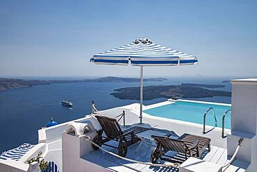 Lawn chairs and swimming pool on hilltop