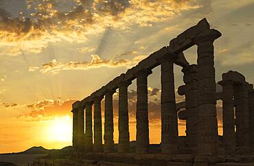 Temple of Poseidon ruins under sunset sky, Cap Sunion, Greece