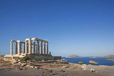 Temple of Poseidon ruins under blue sky, Cap Sunion, Greece